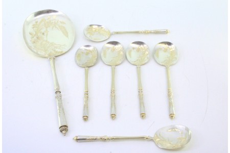 Conjunto de seis colheres de gelado e pá em prata dourada com motivos florais gravados nas conchas.
